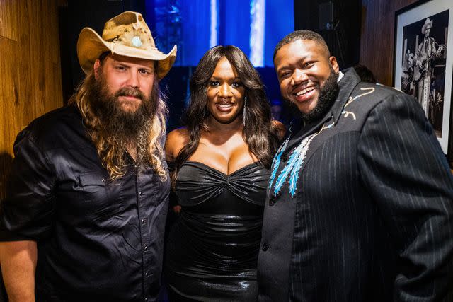<p>John Shearer/Getty</p> Chris Stapleton with Tanya Trotter and Michael Trotter Jr. at the ACM Honors on Aug. 23, 2023 in Nashville