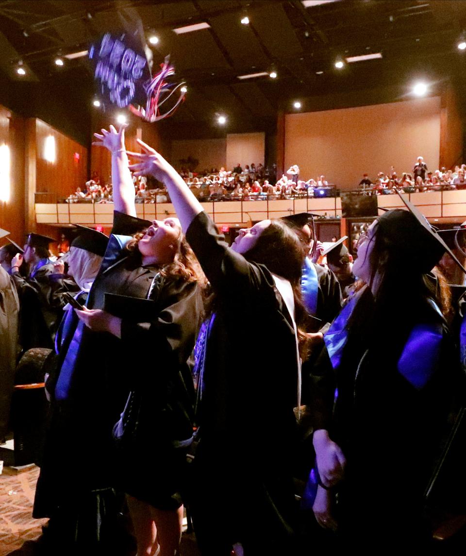 Some of the Rutherford County Virtual School graduates toss their caps at the end of their graduation ceremony at Tucker Theatre at MTSU, on Wednesday, May 15, 2024.