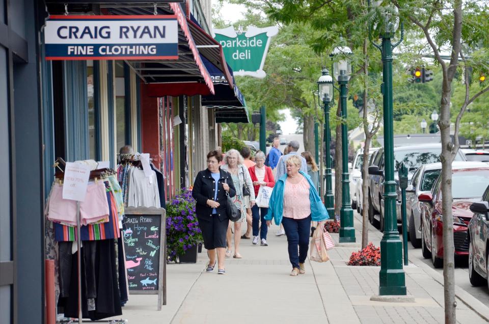 Shoppers walk through downtown Petoskey in July 2019.