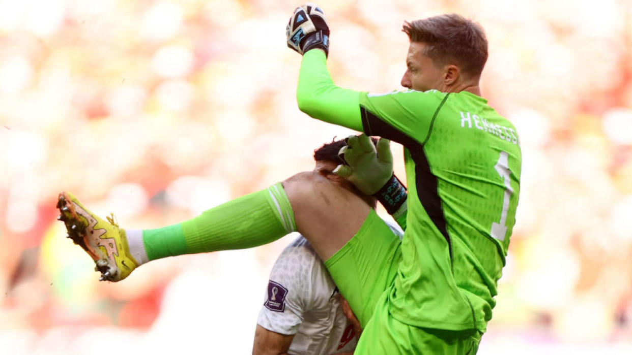 DOHA, QATAR - NOVEMBER 25: Wales' Wayne Hennessey fouls Iran's Mehdi Taremi and subsequently receives a red card and is sent offduring the FIFA World Cup Qatar 2022 Group B match between Wales and IR Iran at Ahmad Bin Ali Stadium on November 25, 2022 in Doha, Qatar. (Photo by Hannah Mckay - Pool / Getty Images)