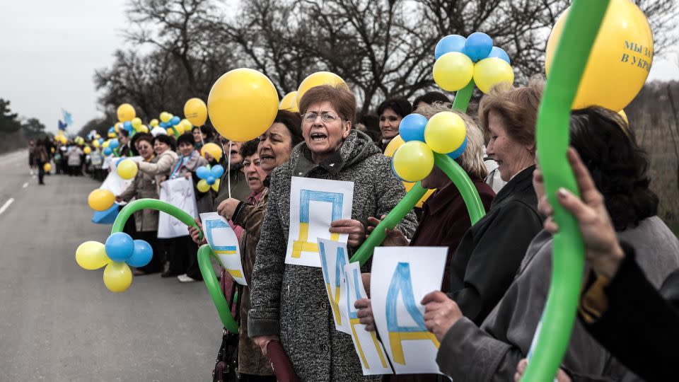 Crimean Tatar women rallying against the war between Russia and Ukraine on the road between Simferopol and Sevastopol in Crimea, Ukraine, on March 8, 2014. - Daniel van Moll/NurPhoto/Corbis/Getty Images