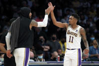 Los Angeles Lakers forward Carmelo Anthony, left, celebrates with guard Malik Monk during the second half of an NBA basketball game against the Detroit Pistons Sunday, Nov. 28, 2021, in Los Angeles. (AP Photo/Alex Gallardo)