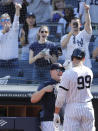 A teammate congratulates New York Yankees' Aaron Judge (99) after Judge' hit a solo home run in the eighth inning of a baseball game against the Chicago White Sox, Saturday, April 13, 2019, in New York. (AP Photo/Kathy Willens)