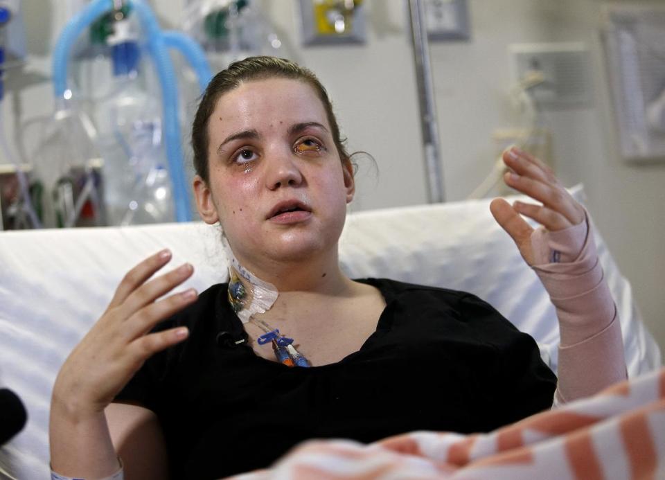 Washington mudslide survivor Amanda Skorjanc, 25, talks to the media while sitting in her hospital bed on Wednesday, April 9, 2014, in Seattle. On March 22, Skorjanic said she was trapped in a pocket formed by her broken couch and pieces of her roof. Skorjanic said that she remembers hearing the voices of several men coming to her aid. She had two broken legs and a broken arm. (AP Photo/The Herald, Dan Bates, Pool)