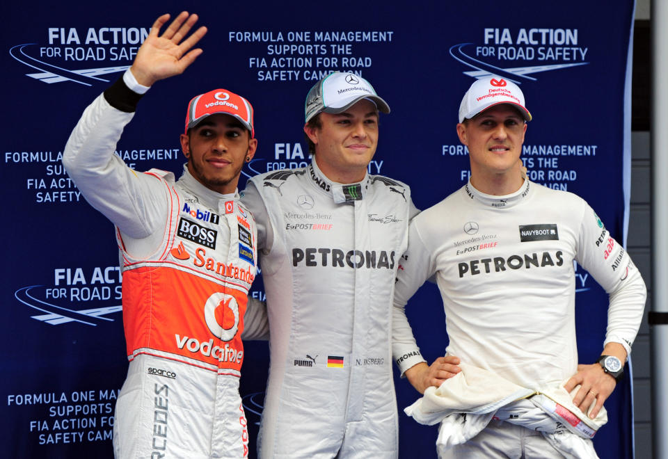 Mercedes-AMG driver Nico Rosberg of Germany (C), McLaren-Mercedes driver Lewis Hamilton of Britain (L) and Mercedes-AMG driver Michael Schumacher of Germany (R) celebrate after the qualifying session of Formula One's Chinese Grand Prix at the Shanghai International Circuit on April 14, 2012.   AFP PHOTO / Mark RALSTON (Photo credit should read MARK RALSTON/AFP/Getty Images)