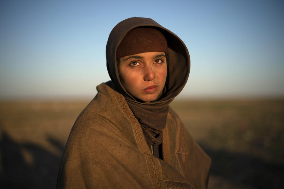 A girl waits to be screened by U.S.-backed Syrian Democratic Forces (SDF) after being evacuated out of the last territory held by Islamic State militants, in the desert outside Baghouz, Syria, Friday, March 1, 2019. (AP Photo/Felipe Dana)