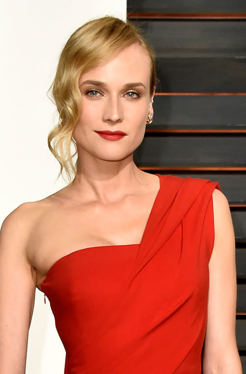 Diane Kruger perfectly pairs a red lip with a memorable Donna Karan Atelier jumpsuit at the Vanity Fair Oscars after party.