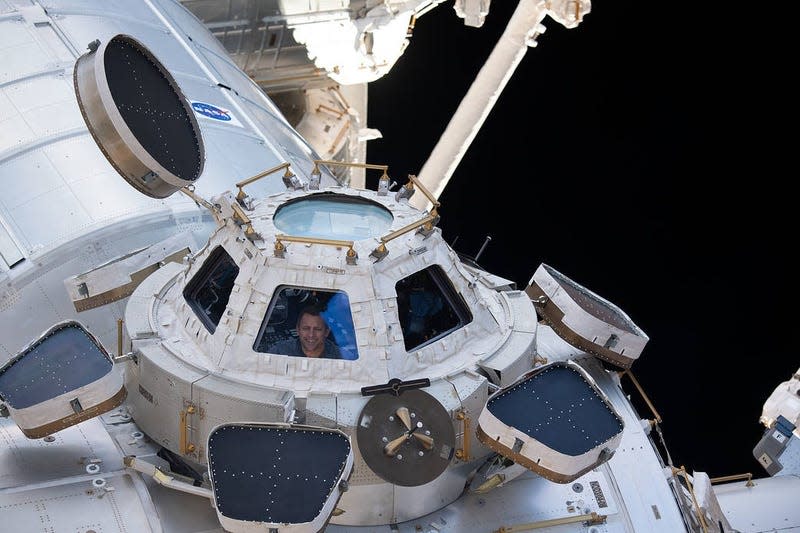 NASA astronaut and Expedition 68 Flight Engineer Josh Cassada looks out through one of the seven windows in the cupola.