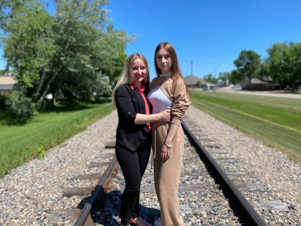 Karina Havina, right, fled Ukraine three weeks after Russia invaded on Feb. 24. She is now living with her aunt, Nelli Voloshanavskiy, left, in Altona, Man. Both women say they feel lucky to be living in a quiet, peaceful community, far from the horrors of war. (Karen Pauls/CBC - image credit)