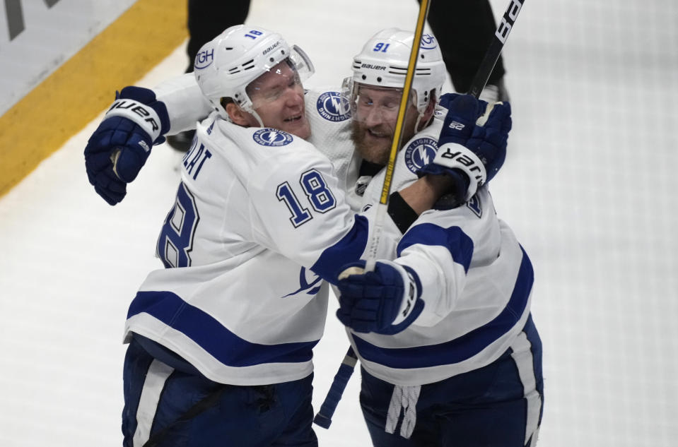 Tampa Bay Lightning left wing Ondrej Palat, left, celebrates his go-ahead goal against the Colorado Avalanche with center Steven Stamkos during the third period of Game 5 of the NHL hockey Stanley Cup Final, Friday, June 24, 2022, in Denver. (AP Photo/David Zalubowski)