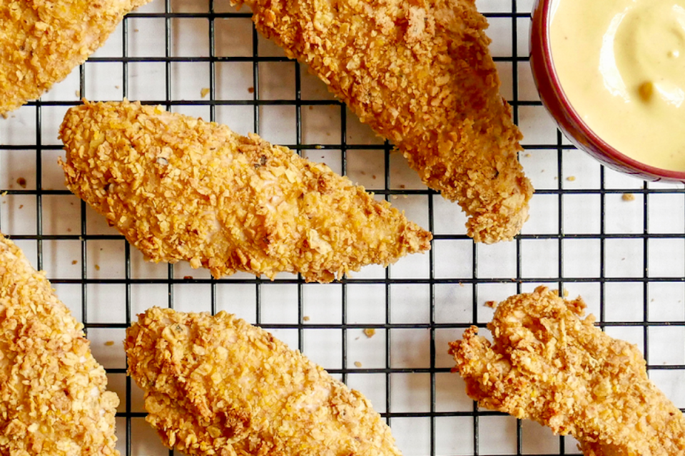 <p>This better-for-you version of <a href="https://www.thedailymeal.com/best-fried-chicken-america-2019?referrer=yahoo&category=beauty_food&include_utm=1&utm_medium=referral&utm_source=yahoo&utm_campaign=feed" rel="nofollow noopener" target="_blank" data-ylk="slk:fried chicken;elm:context_link;itc:0;sec:content-canvas" class="link ">fried chicken</a> tenders comes from the WW Café at Barclays Center in Brooklyn, New York, where the Nets and Islanders play.</p> <p><a href="https://www.thedailymeal.com/recipes/ww-oven-fried-chicken-tenders-recipe?referrer=yahoo&category=beauty_food&include_utm=1&utm_medium=referral&utm_source=yahoo&utm_campaign=feed" rel="nofollow noopener" target="_blank" data-ylk="slk:For the WW Oven Fried Chicken Tenders Recipe, click here.;elm:context_link;itc:0;sec:content-canvas" class="link ">For the WW Oven Fried Chicken Tenders Recipe, click here.</a></p>