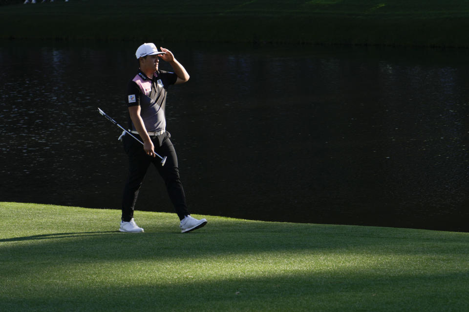 Sungjae Im, of South Korea, shades his eyes as walks down the 16th fairway during the first round at the Masters golf tournament on Thursday, April 7, 2022, in Augusta, Ga. (AP Photo/Charlie Riedel)