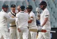 Australia's Nathan Lyon (C) celebrates with teammates dismissing after New Zealand's Mark Craig (R) for 11 runs during the first day of the third cricket test match at the Adelaide Oval, in South Australia, November 27, 2015. REUTERS/David Gray