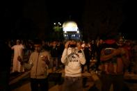 Worshippers pray in front of the Dome of the Rock in the compound known to Muslims as Noble Sanctuary and to Jews as Temple Mount in Jerusalem's Old City, after it was reopened following a coronavirus closure