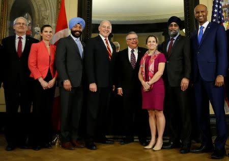 U.S. Homeland Security Secretary John Kelly (4th L) poses for a group photo with Transport Minister Marc Garneau (L), Science Minister Kirsty Duncan (2nd L), Innovation, Science and Economic Development Minister Navdeep Bains (3rd L), Public Safety Minister Ralph Goodale (4th R), Foreign Minister Chrystia Freeland (3rd R), Defence Minister Harjit Sajjan (2nd R), and Immigration Minister Ahmed Hussen (R) on Parliament Hill in Ottawa, Ontario, Canada, March 10, 2017. REUTERS/Chris Wattie