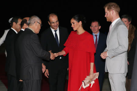 Britain's Prince Harry and Meghan, Duchess of Sussex, are welcomed by officials at the Casablanca Airport in Casablanca, Morocco, February 23, 2019. REUTERS/Hannah McKay/Pool