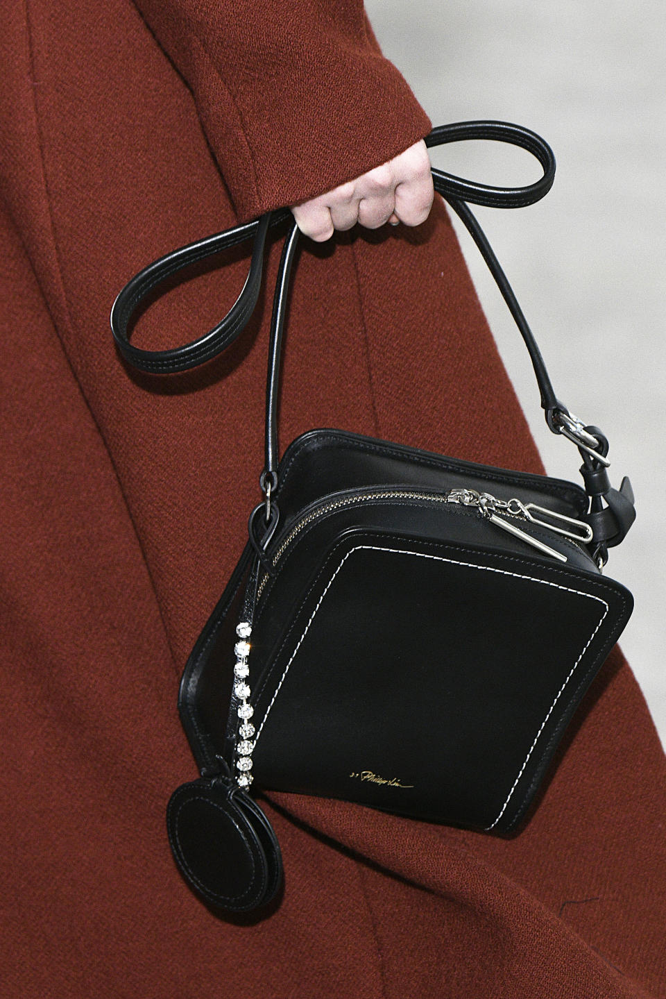 <p>A model carries a small, boxy black bag from the 3.1 Phillip Lim show. (Photo: Getty Images) </p>