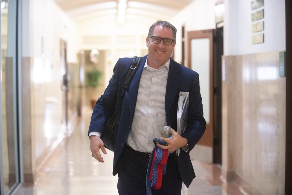 Stephen Wade carries a few items back to his former office Wednesday morning at City Hall while getting settled into his new job as city manager.
