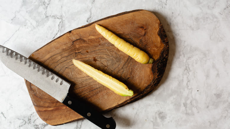 carrot cut in half with knife