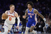 New York Knicks' Donte DiVincenzo (0) tries to get past Philadelphia 76ers' Kelly Oubre Jr. (9) during the first half of Game 6 in an NBA basketball first-round playoff series, Thursday, May 2, 2024, in Philadelphia. (AP Photo/Matt Slocum)