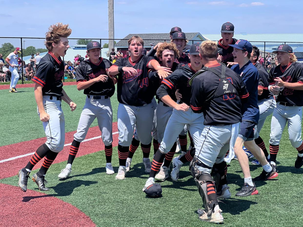 Harrison baseball players celebrate a comeback victory to win the Class 4A, Sectional 7 championship over McCutcheon.