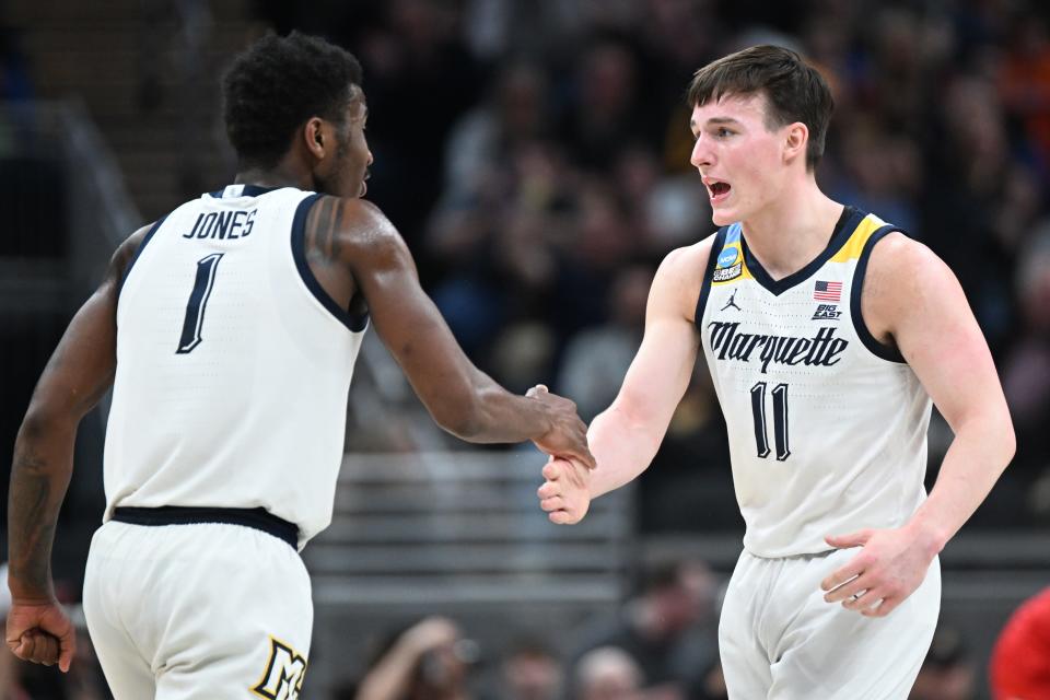 Marquette guards Tyler Kolek (11) and Kam Jones (1) celebrate against the Western Kentucky in the first round of the NCAA Tournament at Gainbridge FieldHouse.