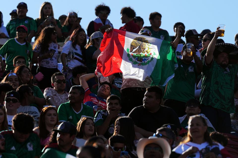 A fan holds up a Mexican flag before the game against Qatar at Levi's Stadium.