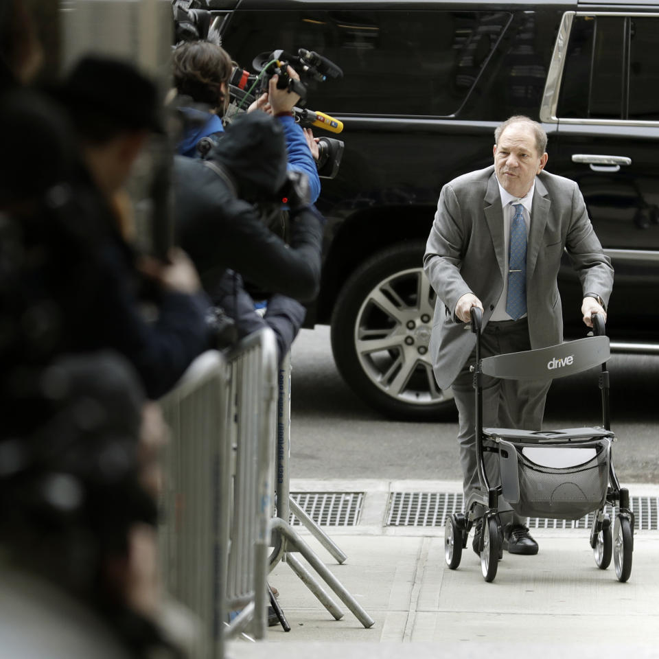 Harvey Weinstein talks to reporters as he arrives at a Manhattan courthouse for his rape trial in New York, Tuesday, Feb. 18, 2020. (AP Photo/Seth Wenig)