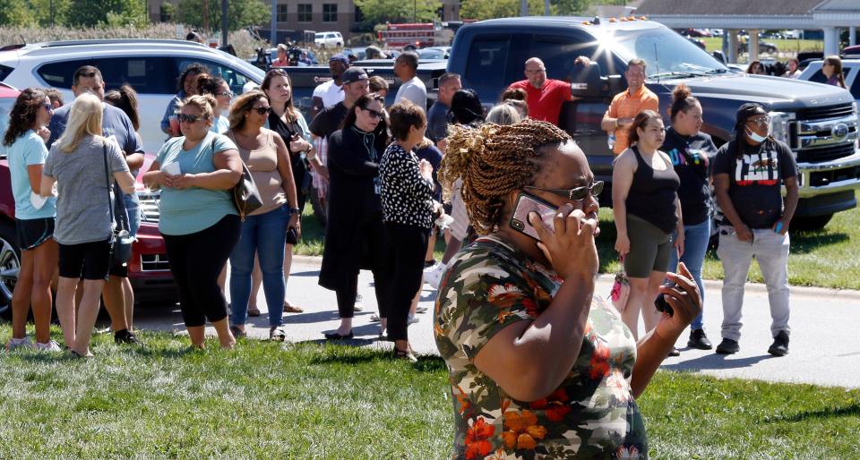 Parents wait around Lake Central High School to hear information about their children during a lock down for a report of an active shooter incident Wednesday, Sept. 8, 2021 in St. John, Ind.