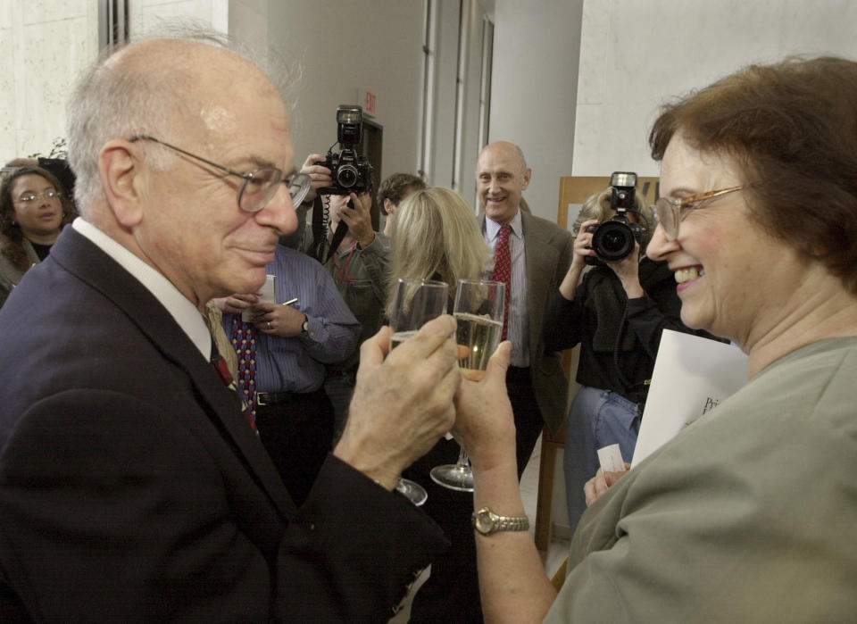 FILE - Psychology professor Daniel Kahneman, left, a U.S. and Israeli citizen based at Princeton University, and his wife Anne Treisman, also a psychology professor at the university, have champagne following a news conference at the school in Princeton, N.J., to give his reaction to winning the Nobel prize in economics, Oct. 9, 2002. Kahneman died Wednesday, March 27, 2024, at the age of 90. (AP Photo/Daniel Hulshizer, File)