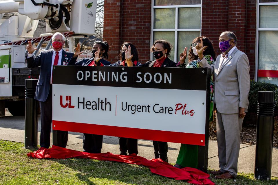 UofL officials and local dignitaries held their 'L's Up' after unveiling a sign announcing the expansion of UofL Health - Urgent Care Plus in west Louisville's parkland neighborhood. March 23, 2020