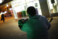 Alexei, an animal activist who would only give his first name, carries a stray half-breed Labrador to his car after finding it at a cafe’s back door, Monday, Feb. 10, 2014, in central Sochi, Russia, home of the 2014 Winter Olympics. Alexei is one of a dozen people in the emerging movement of animal activists in Sochi alarmed by reports that the city has contracted the killing of thousands of stray dogs before and during the Olympic Games. Stray dogs are a common sight on the streets of Russian cities, but with massive construction in the area the street dog population in Sochi and the Olympic park has soared. Useful as noisy, guard dogs, workers feed them to keep them nearby and protect buildings. They soon lose their value and become strays. Tonight, a few dogs will be taken on their way to a new life in Moscow. (AP Photo/David Goldman)