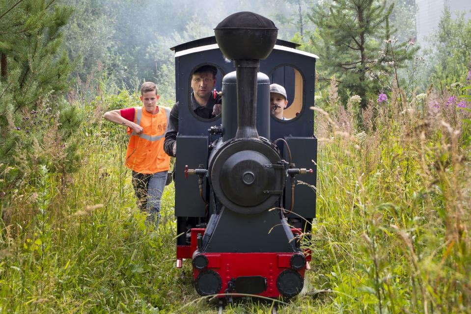 A steam train travels at a private railway near Pavel Chilin's cottage home in Ulyanovka village, about 50 kilometers (31 miles) south of St.Petersburg, Russia Sunday, July 19, 2020. It took Chilin more than 10 years to build the 350-meter-long miniature personal narrow-gauge railway complete with various branches, dead ends, circuit loops, and even three bridges. (AP Photo/Dmitri Lovetsky)