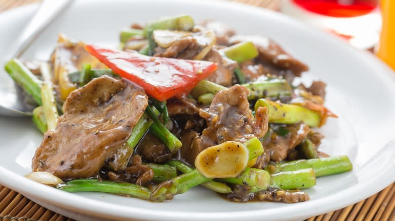 Ostrich steak stir fry and veggies on a plate