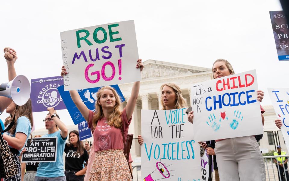Anti-abortion demonstrators hold signs outside the US Supreme Court in Washington - Eric Lee /Bloomberg