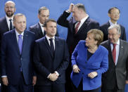 German Chancellor Angela Merkel, front second left, waits for the arrival of leaders prior to a group photo at a conference on Libya at the chancellery in Berlin, Germany, Sunday, Jan. 19, 2020. Front row left to right, Turkish President Recep Tayyip Erdogan, French President Emmanuel Macron, and United Nations Secretary General Antonio Guterres. Back row left to right, European Council President Charles Michel, German Foreign Minister Heiko Maas, U.S. Secretary of State Mike Pompeo and Chinese State Councilor Yang Jiechi. (AP Photo/Michael Sohn)