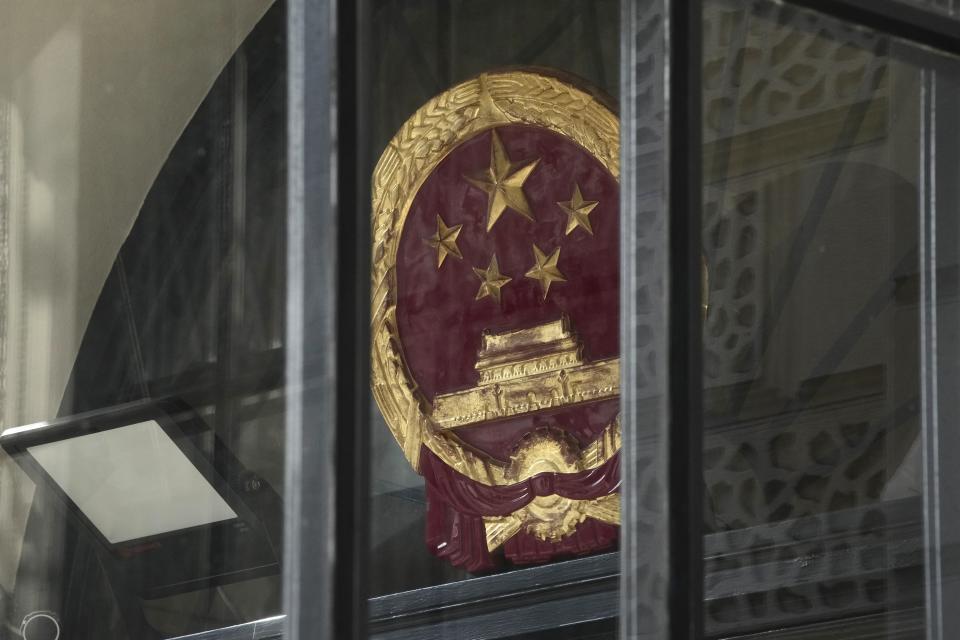 Chinese national emblem is displayed at the Chinese embassy in London, Monday, Sept. 11, 2023. Prime Minister Rishi Sunak has chastised China's premier for what he called unacceptable interference in British democracy after a newspaper reported that a researcher in Parliament was arrested earlier this year on suspicion of spying for Beijing. (AP Photo/Kin Cheung)