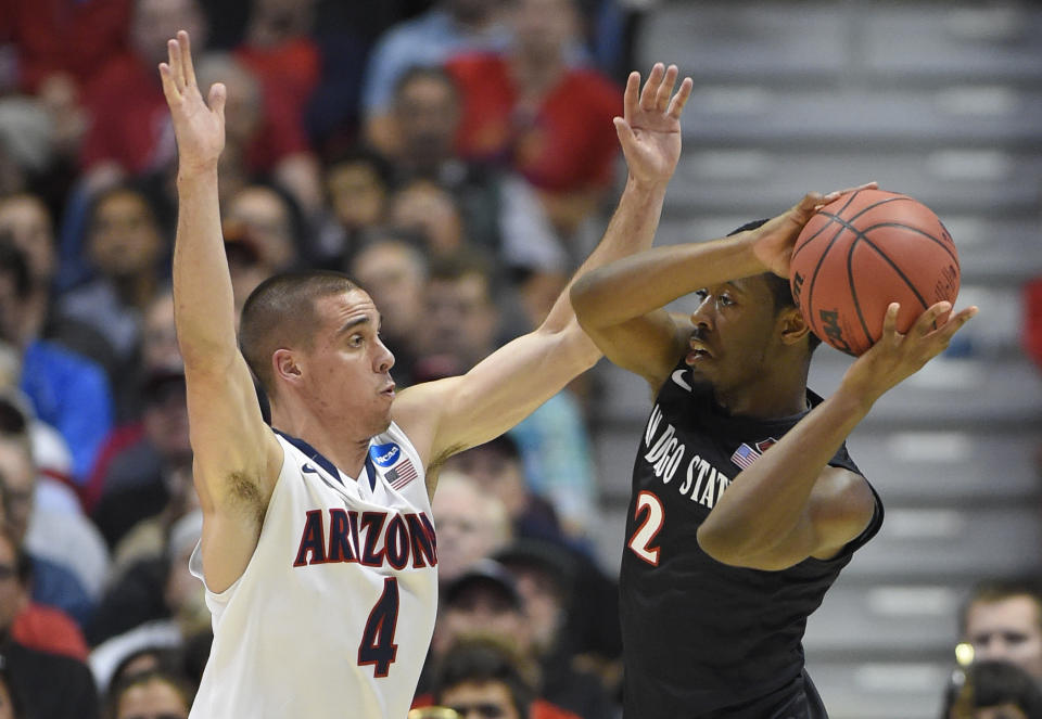 San Diego State guard Xavier Thames (2) looks to pass around Arizona guard T.J. McConnell (4) during the first half in a regional semifinal of the NCAA men's college basketball tournament, Thursday, March 27, 2014, in Anaheim, Calif. (AP Photo/Mark J. Terrill)