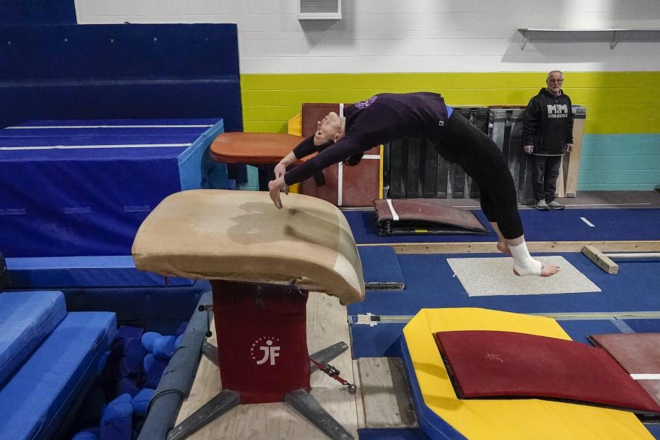 Former gymnastics world champion and Olympic silver medalist Chellsie Memmel works out with her father and coach Andy Memmel Thursday, Feb. 18, 2021, in New Berlin, Wisc. (AP Photo/Morry Gash)