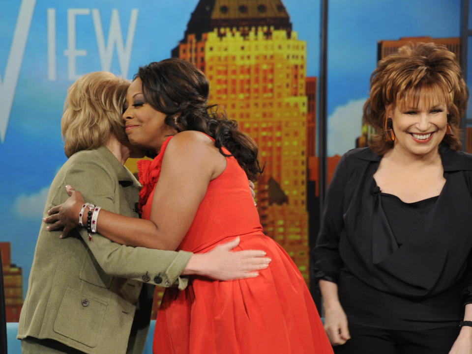 In this image released by ABC, co-host Barbara Walters, left embraces former co-host Star Jones as Joy Behar, right, looks on during a broadcast of the daytime talk show "The View," Wednesday, Feb. 22, 2012, in New York. Jones made a guest appearance Wednesday after quitting the show six years ago. (AP Photo/ABC, Ida Mae Astute)