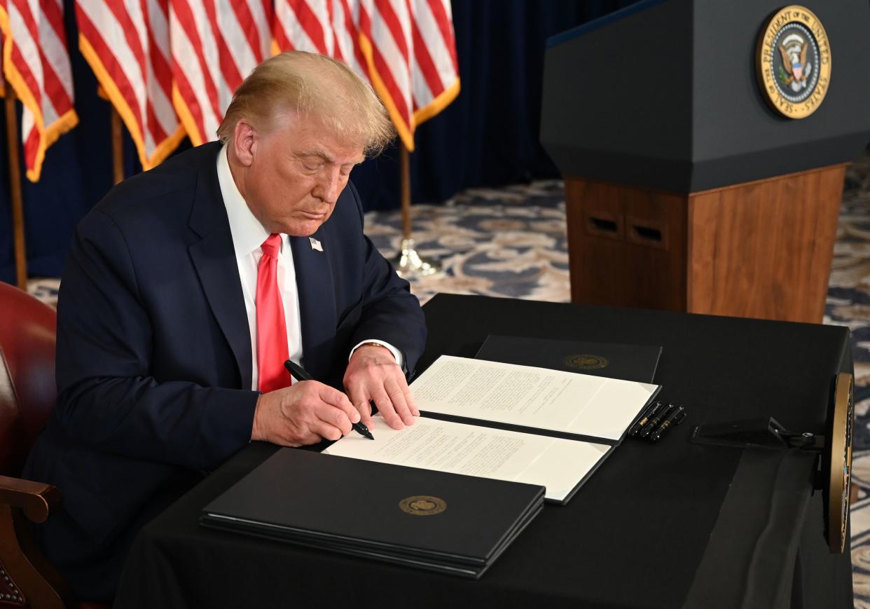 US President Donald Trump signs executive orders extending coronavirus economic relief, during a news conference in Bedminster, New Jersey, on August 8, 2020. (Photo by JIM WATSON / AFP) (Photo by JIM WATSON/AFP via Getty Images)