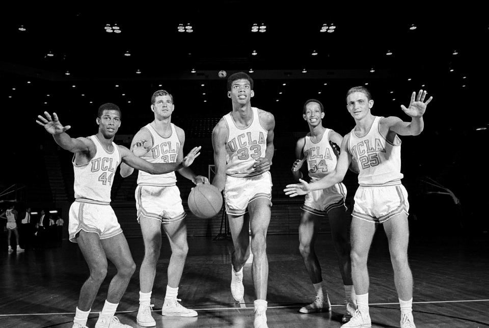 FILE - Lew Alcindor (33), later known as Kareem Abdul Jabbar, poses with his UCLA teammates as basketball practice gets underway in Los Angeles, Oct. 14, 1966. Players from left are, Mike Warren (44), a guard from South Bend, Ind.; Mike Lynn (35), forward from Covina, Ca.; Alcindor; Edgar Lacey (54), forward from Los Angeles; and Don Saffer (25), guard from Los Angeles. (AP Photo/File)