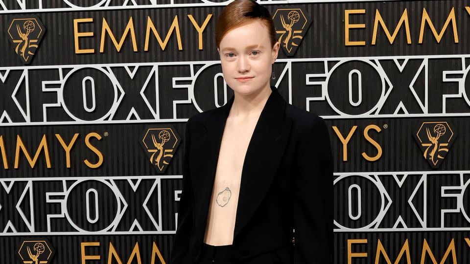 “Yellowjackets” actor's Liv Hewson, who opted out of gendered acting categories, showed off a pearl oyster tattoo, going shirtless in a black velveteen jacket with wide-leg pants and double train by Moschino. The star's jewelry was by State Property and Samsares. - Frazer Harrison/Getty Images