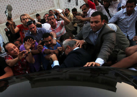 File photo shows men attacking former presidential candidate Ahmed Shafiq (C) as he leaves a polling station after casting his vote in Cairo, Egypt, May 23, 2012. REUTERS/Amr Abdallah Dalsh/File Photo