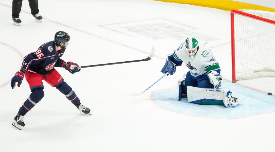 Jan 15, 2024; Columbus, Ohio, USA; Columbus Blue Jackets right wing Kirill Marchenko (86) scores the winning goal past Vancouver Canucks goaltender Casey DeSmith (29) during the shootout in the NHL hockey game at Nationwide Arena. The Blue Jackets won 4-3.