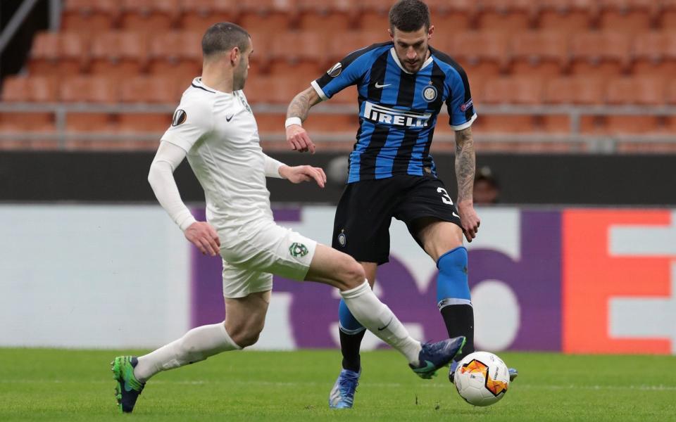 Inter Milan's Cristiano Biraghi (R) kicking to score a goal during during the UEFA Europa league round of 32 second-leg football match between Inter Milan and Ludogorets Razgrad at San Siro Stadium in Milan on February 27, 2020. - The match was held behind closed doors as a safety measure due to the spread of COVID-19 - EMILIO ANDREOLI /  AFP