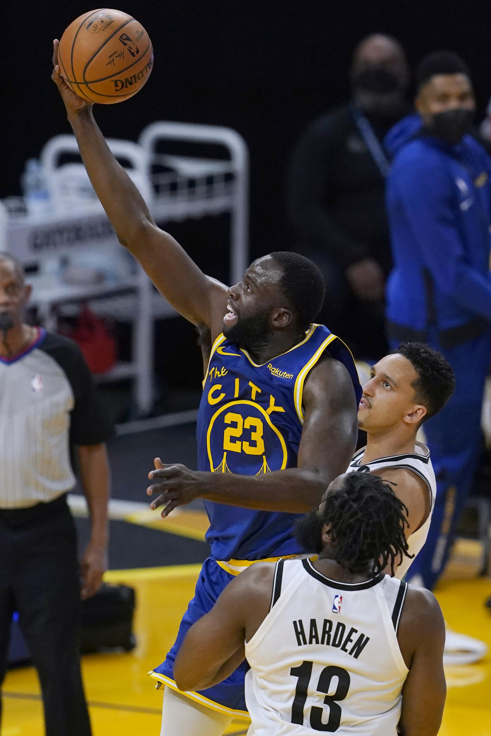 Golden State Warriors forward Draymond Green (23) shoots against Brooklyn Nets guard James Harden (13) and guard Landry Shamet during the first half of an NBA basketball game in San Francisco, Saturday, Feb. 13, 2021. (AP Photo/Jeff Chiu)