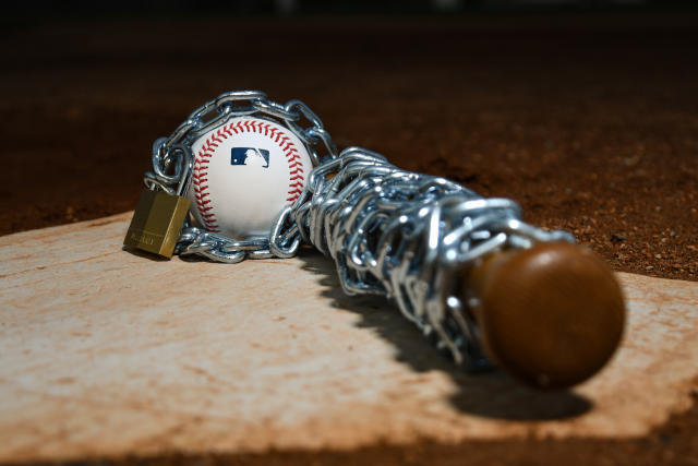 An Official Rawlings Major League baseball sits with a glove, lock News  Photo - Getty Images