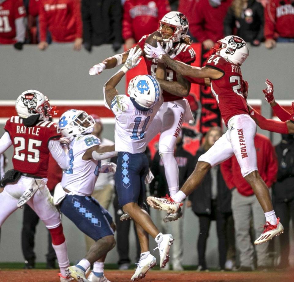 N.C. State Derrick Pitts (24) intercepts a Sam Howell pass on the final play of the game to secure the Wolfpack’s 34-30 victory over North Carolina on Friday, November 26, 2021 at Carter-Finley Stadium in Raleigh, N.C.