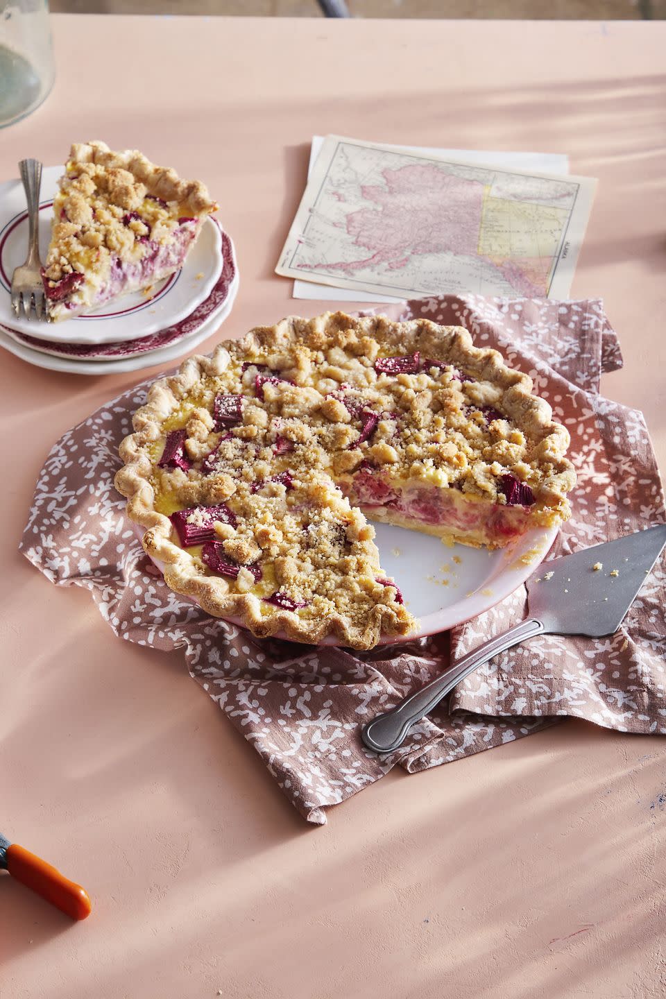 rhubarb custard pie in a pie plate with a slice removed to show the inside